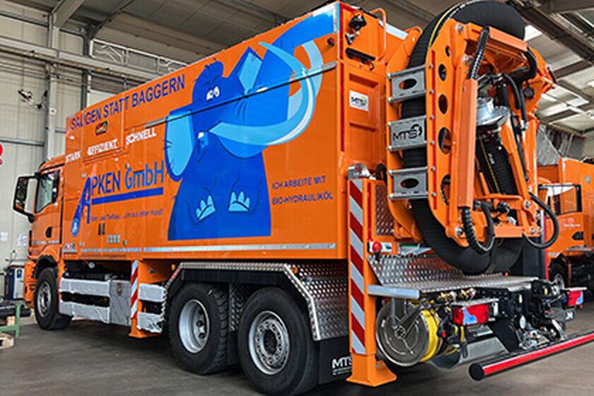 Saugwagen - Apken GmbH Ein großer orangefarbener Saugwagen von hinten.